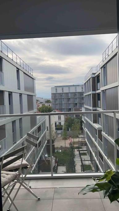 a view of a building from a balcony at Chic &amp; moderne appartement - proximité métro in Asnières-sur-Seine