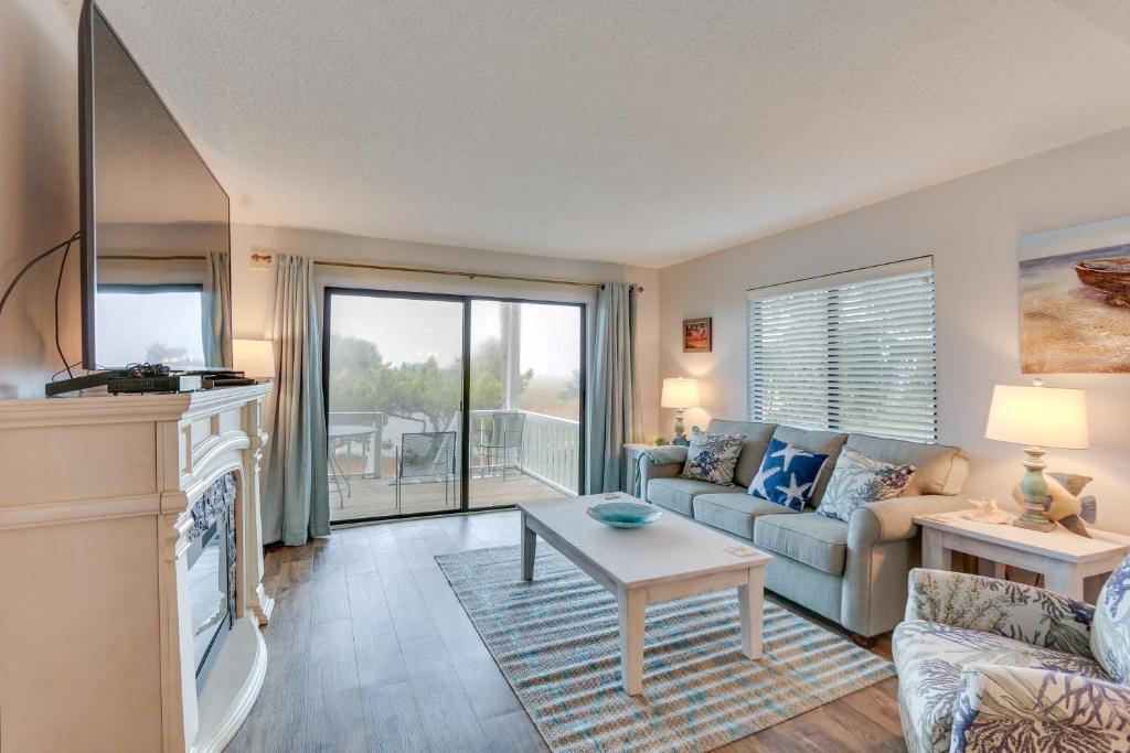a living room with a couch and a table at Luxe Island Condo with Deck Play, Swim and Relax! in Oceanmarsh Subdivision