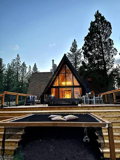 a large wooden house with a large window at Majestic A-Frame on 5 acres! in Sisters