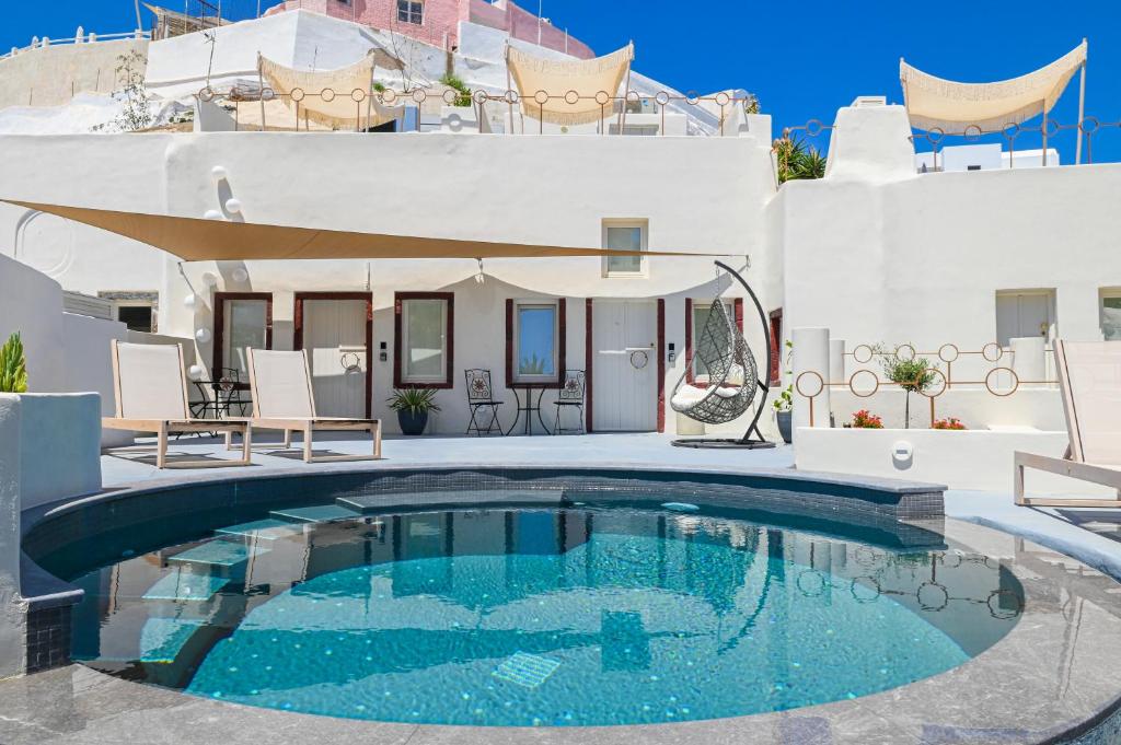 a swimming pool in front of a house at Naos Suites in Vóthon