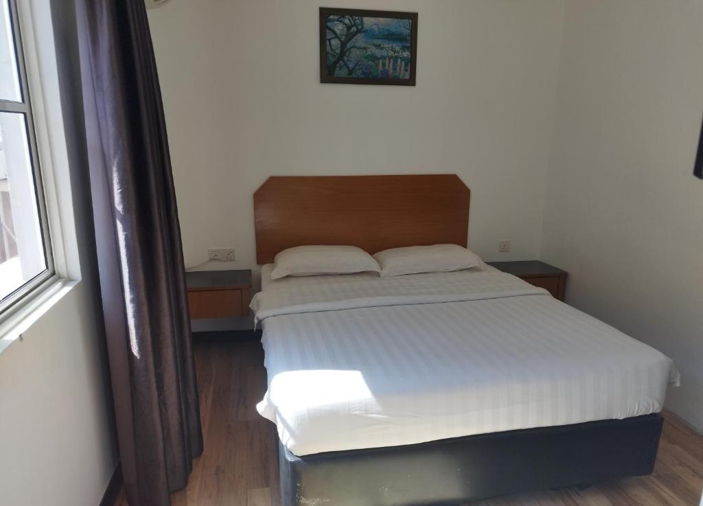 Postel nebo postele na pokoji v ubytování Marine Bay Hotel
