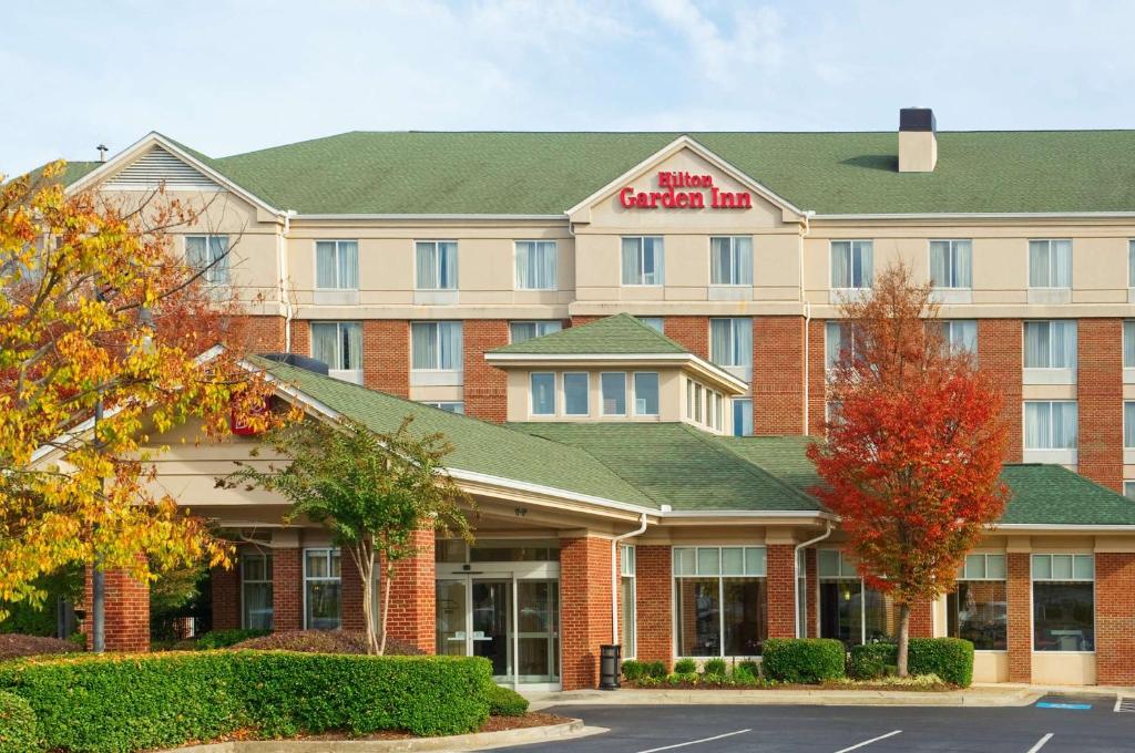 a rendering of a hotel with a sign that reads embassy inn at Hilton Garden Inn Atlanta North/Johns Creek in Johns Creek
