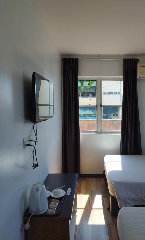 Postel nebo postele na pokoji v ubytování Marine Bay Hotel