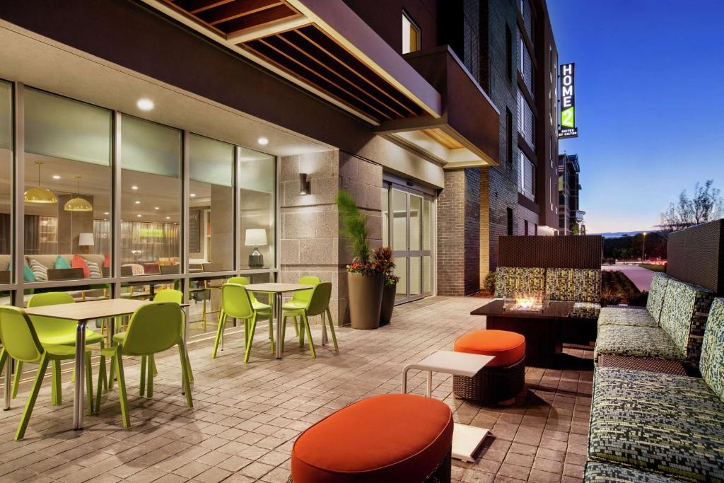 a patio with tables and chairs on a building at Home2 Suites By Hilton Silver Spring in Silver Spring