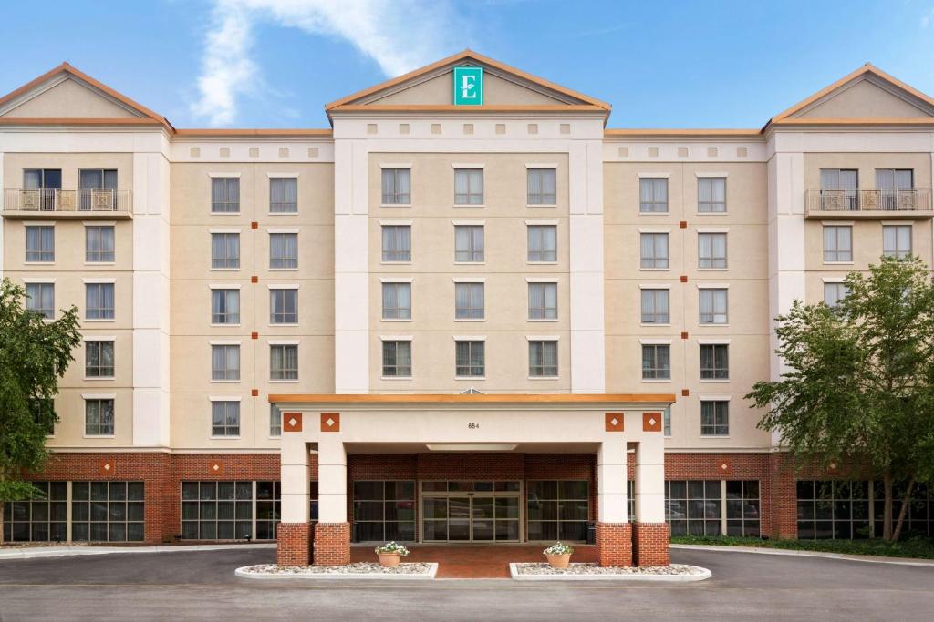 a large white building with a green cross on top at Embassy Suites Newark - Wilmington/South in Newark