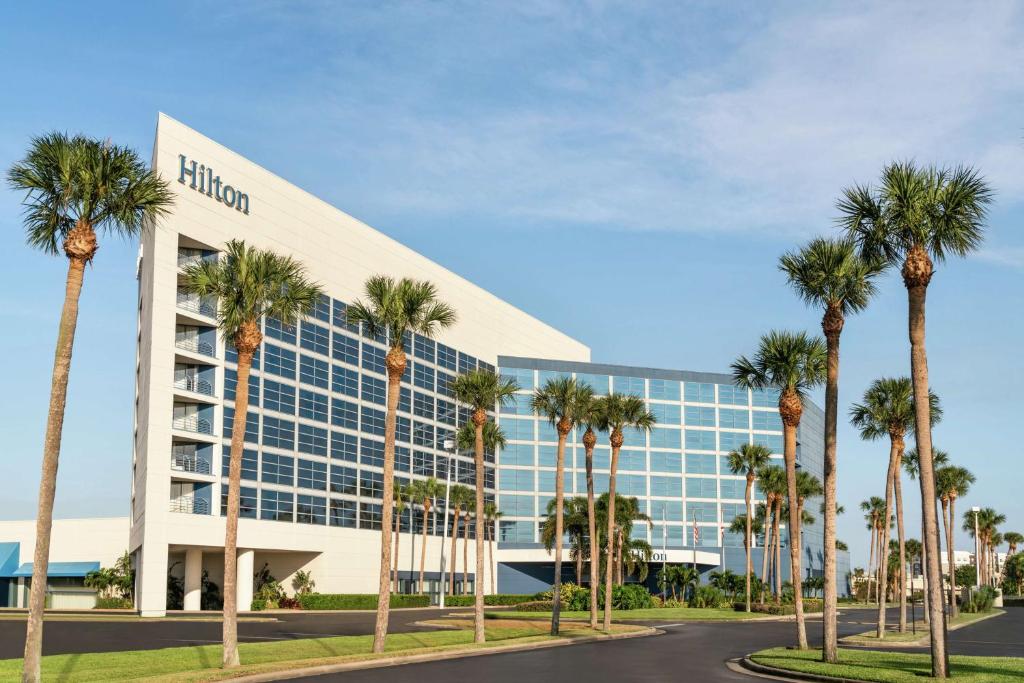 a rendering of a biloxi office building with palm trees at Hilton Melbourne in Melbourne