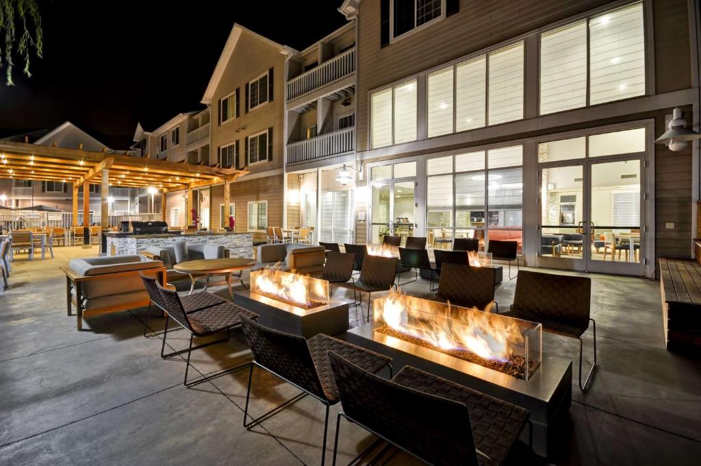 a restaurant with a fireplace in front of a building at Homewood Suites by Hilton - Oakland Waterfront in Oakland