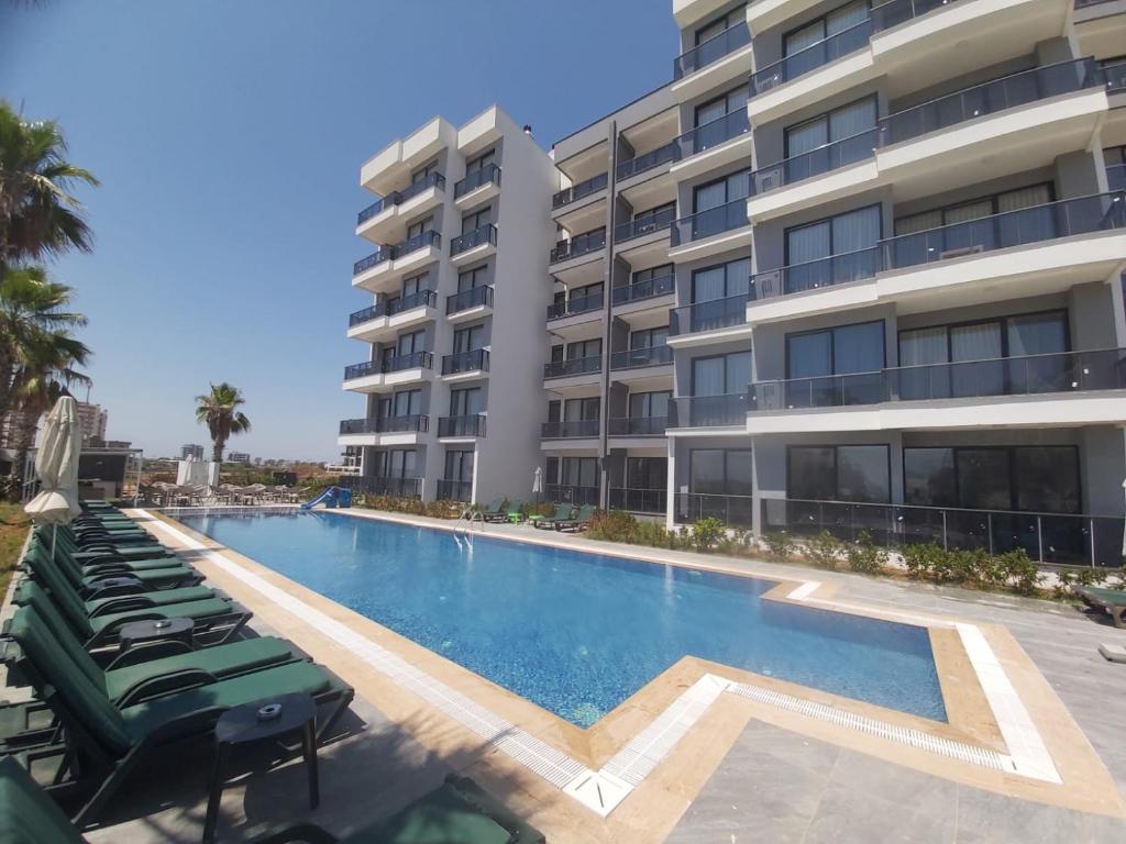 a swimming pool in front of a building at Ethica Suite Luxury Houses in Aksu