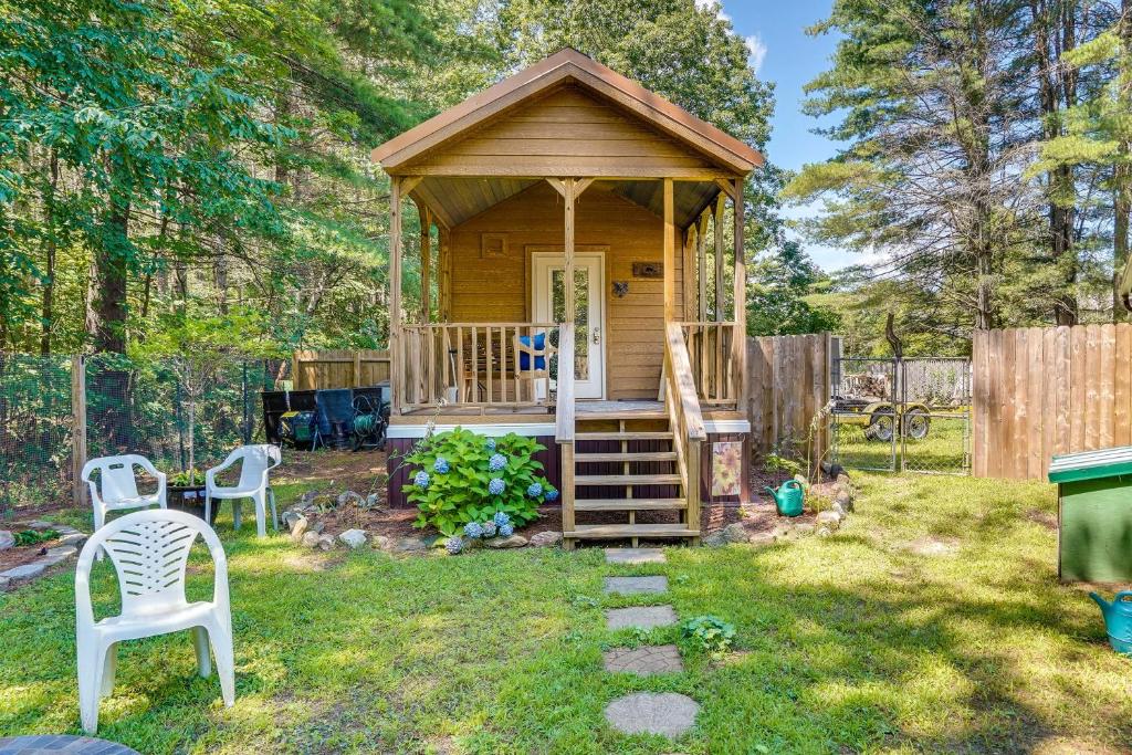 a small cabin with a gazebo in a yard at Mayfield Tiny Home with Porch, Walk to Beaches! in Benson
