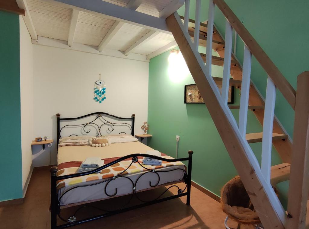 a bedroom with a bed and a staircase at Guestroom Happynest no.3 in Melíssia