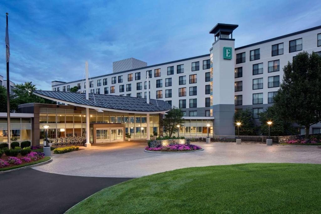 a large white building with a clock tower at Embassy Suites by Hilton Boston Marlborough in Marlborough