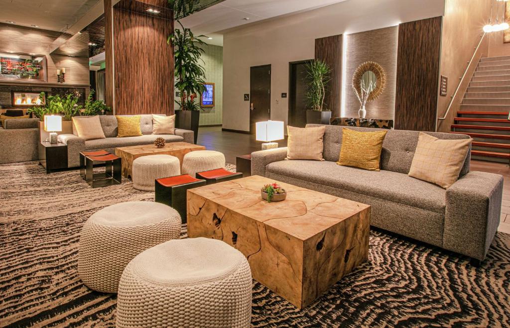 a lobby with couches and a table and chairs at Hilton Garden Inn Seattle Downtown in Seattle