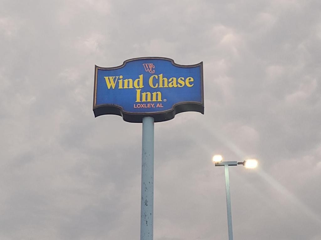 a wind change inn sign on top of a pole at Wind Chase Inn in Loxley
