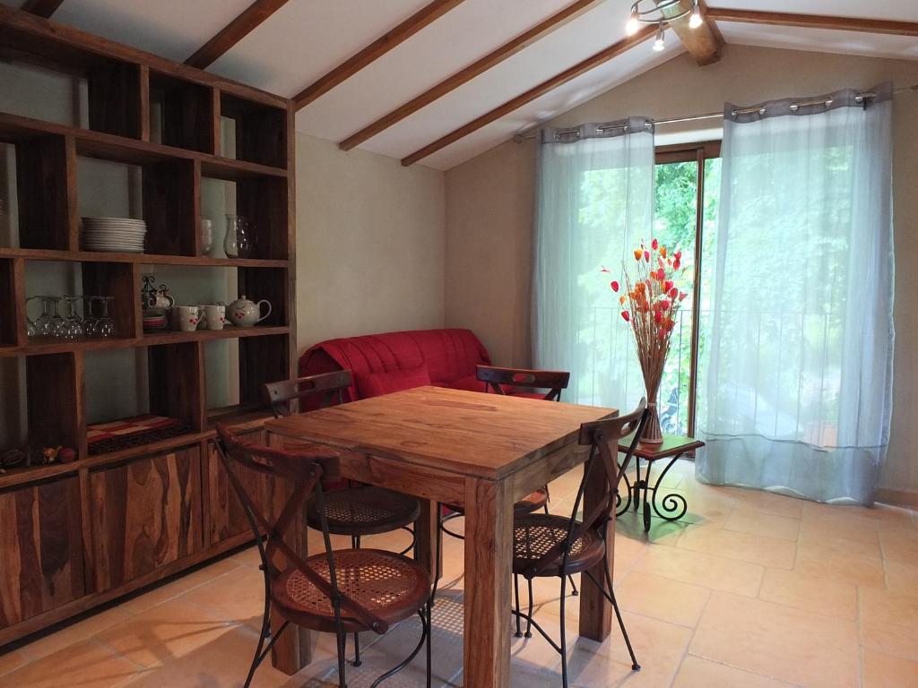 a dining room with a wooden table and chairs at Gite Mas Des Combes in Mandagout