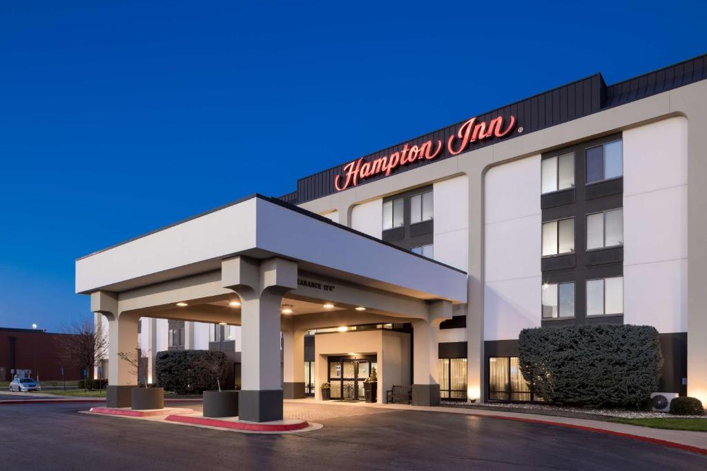 a white building with a sign that reads virginia city at Hampton Inn Bentonville-Rogers in Rogers