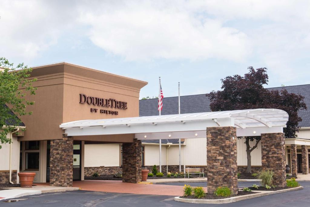 a rendering of the front of a building with an american flag at DoubleTree by Hilton Cleveland – Westlake in Westlake