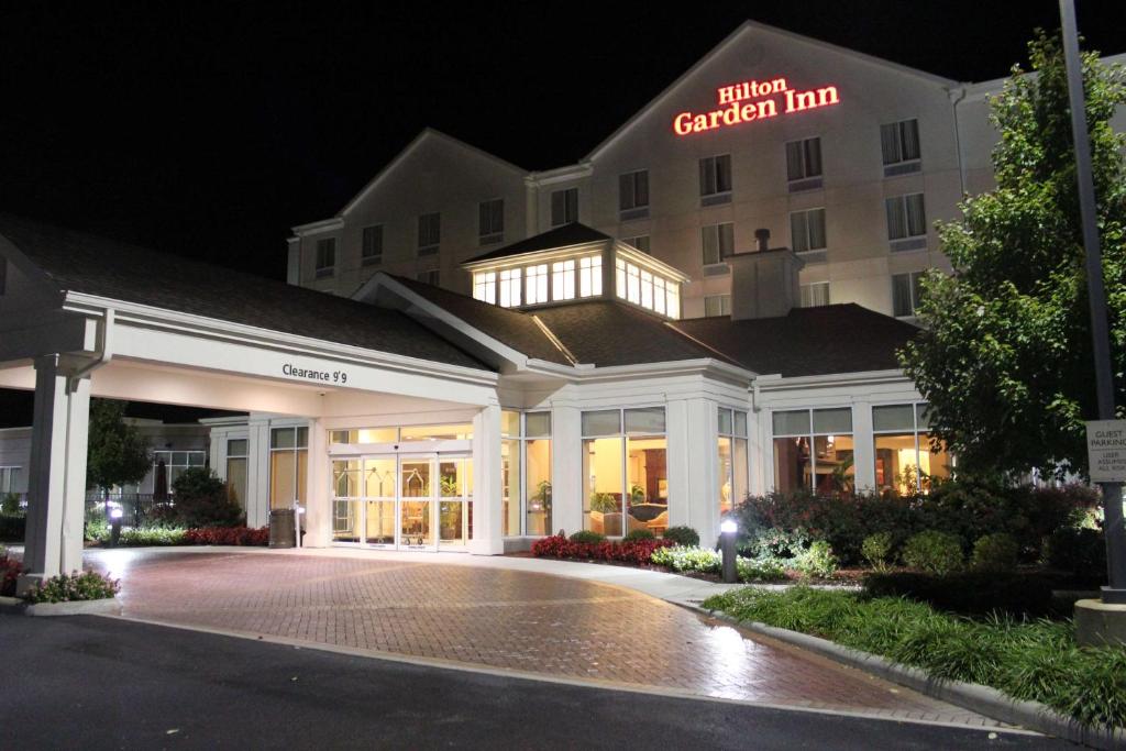 a hotel exterior at night with a hotel garden inn at Hilton Garden Inn Cincinnati Blue Ash in Blue Ash