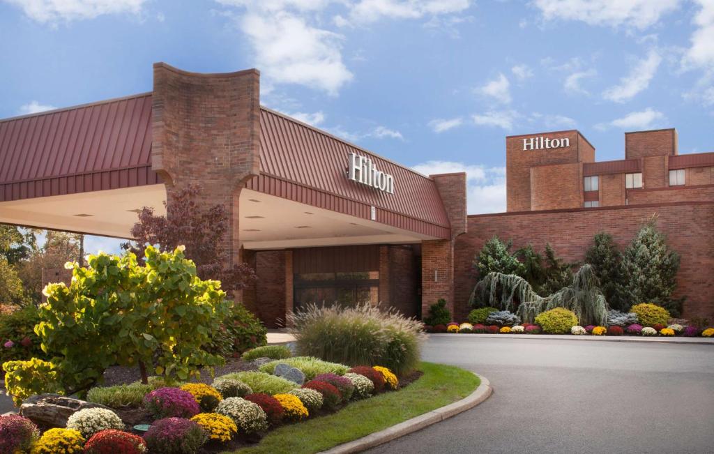 a building with a lot of flowers in front of it at Hilton Parsippany in Parsippany