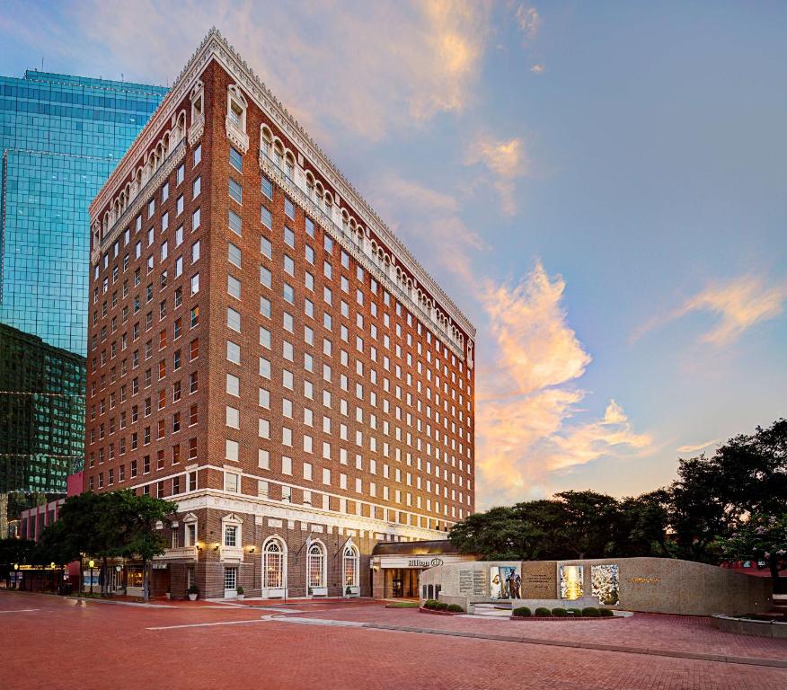 a large building with a clock on the side of it at Hilton Fort Worth in Fort Worth