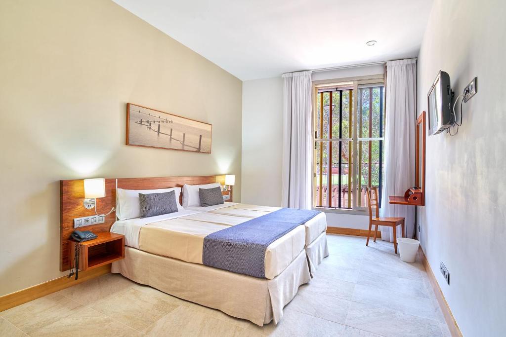 a bedroom with a large bed and a window at Hotel Torre Del Conde in San Sebastián de la Gomera
