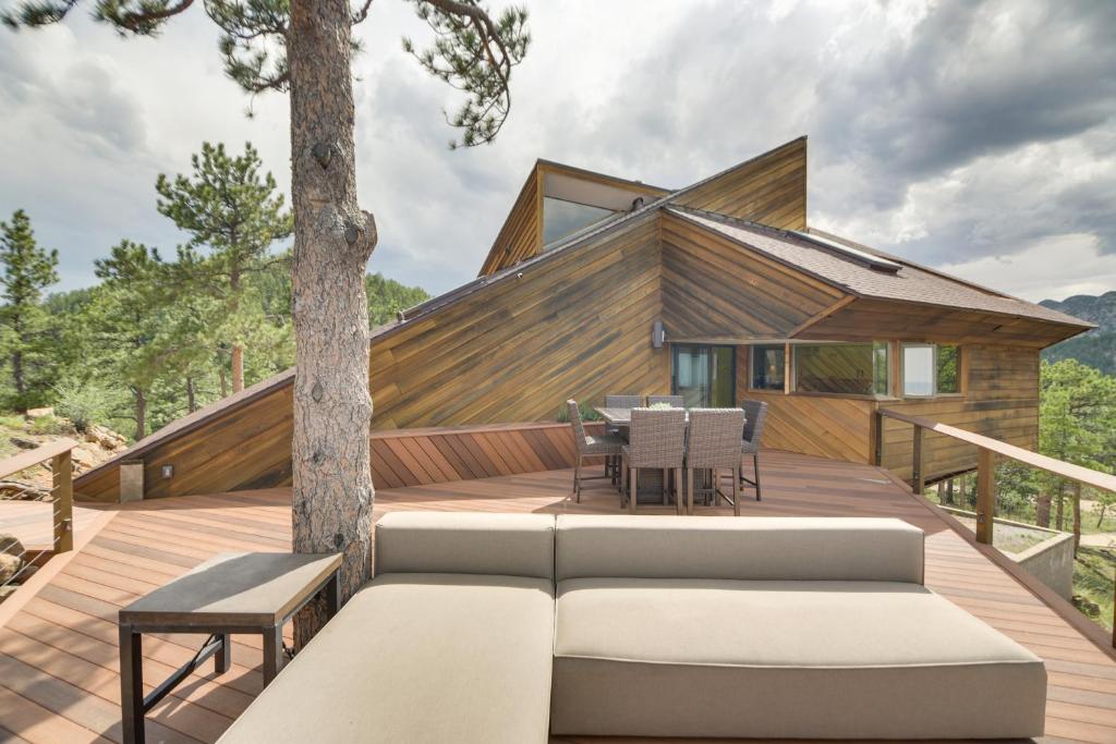 a house on a deck with a couch at Luxe Boulder Barrett House on Mtn Peak with Hot Tub in Boulder