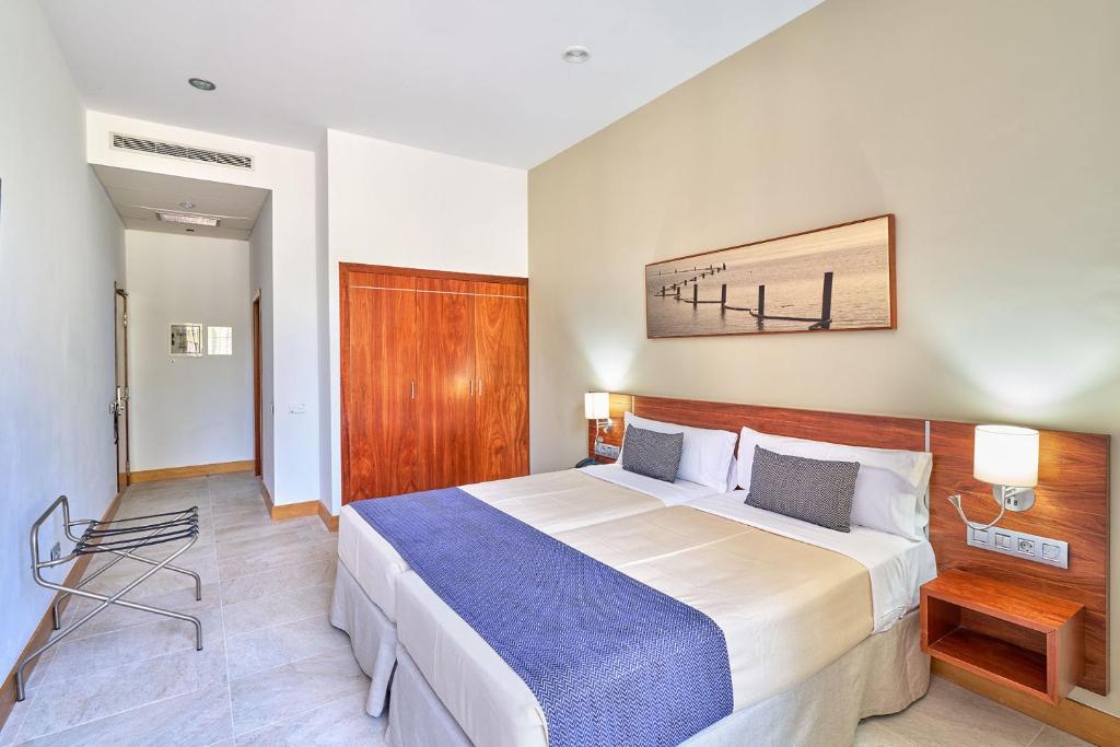 a bedroom with a large bed in a room at Hotel Torre Del Conde in San Sebastián de la Gomera