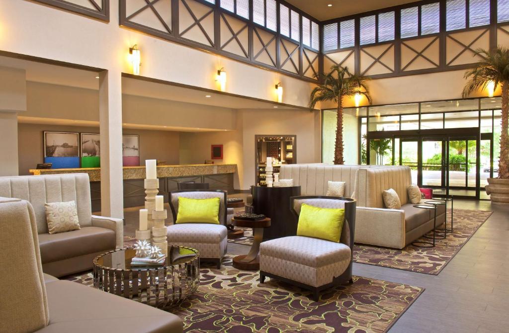 a lobby of a hotel with couches and chairs at Hilton Tampa Airport Westshore in Tampa