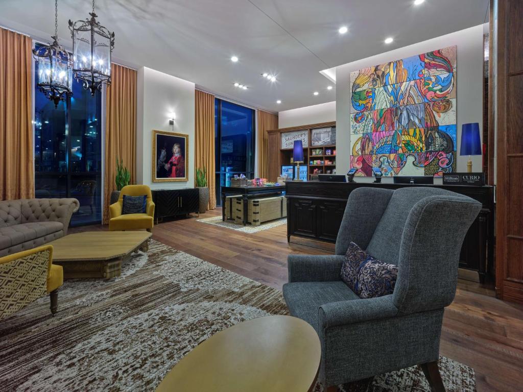 a living room with a couch and a table at The Peregrine Omaha Downtown Curio Collection By Hilton in Omaha