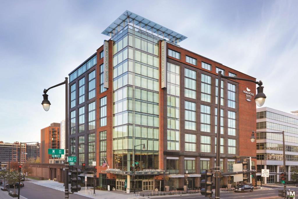 a tall building with glass windows on a city street at Homewood Suites by Hilton Washington DC Capitol-Navy Yard in Washington