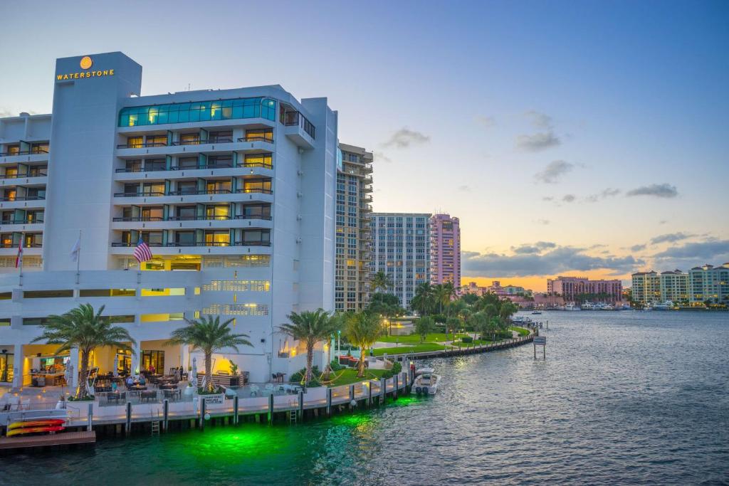 a large building next to a body of water at Waterstone Resort & Marina Boca Raton, Curio Collection by Hilton in Boca Raton