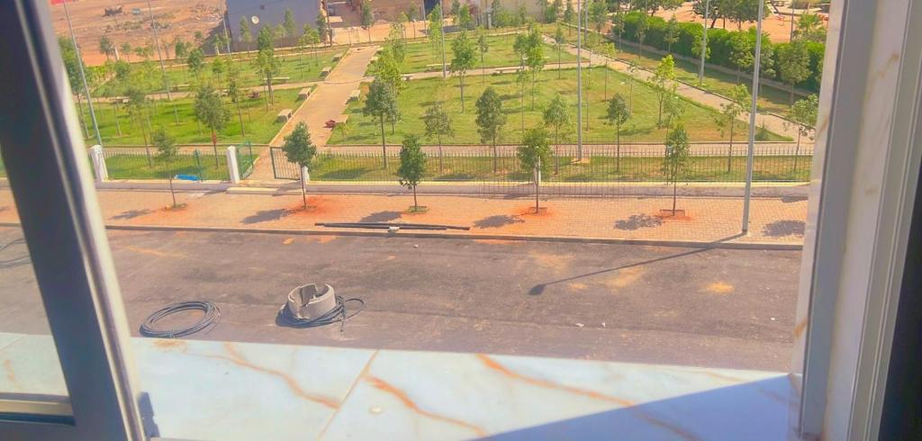 a view of an empty parking lot from a window at traditional moderne apartment in mohammedia in Ben Yakhlef