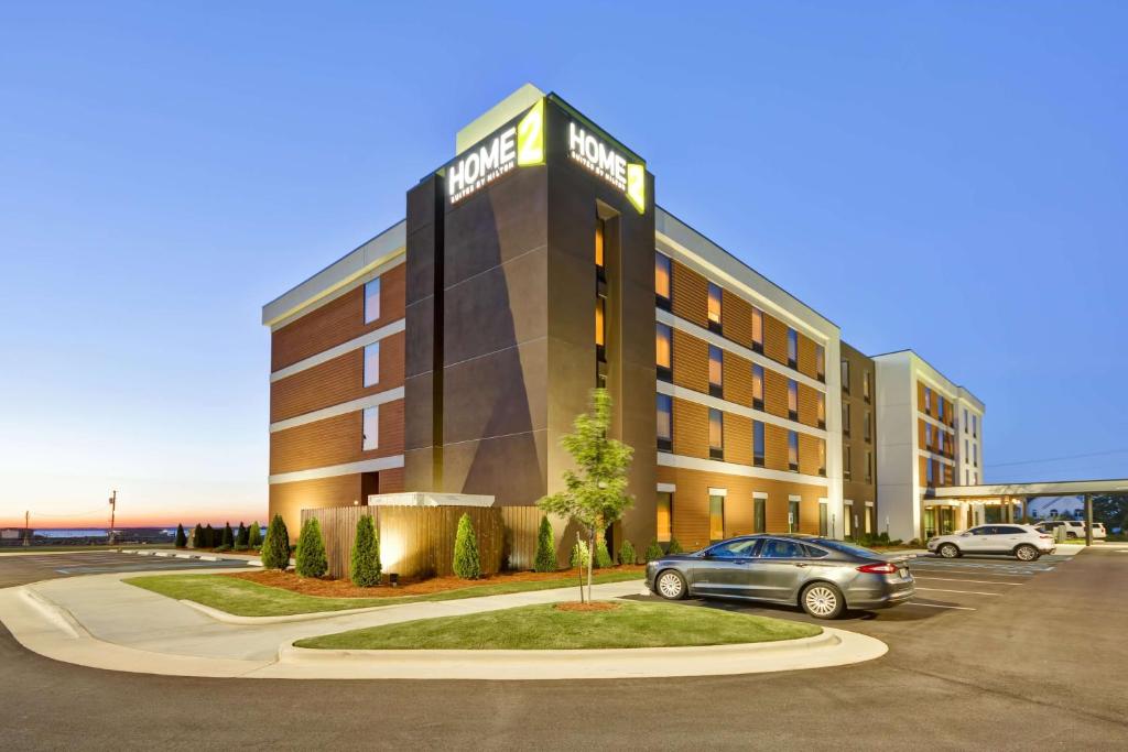 a hotel with a car parked in a parking lot at Home2 Suites By Hilton Decatur Ingalls Harbor in Decatur