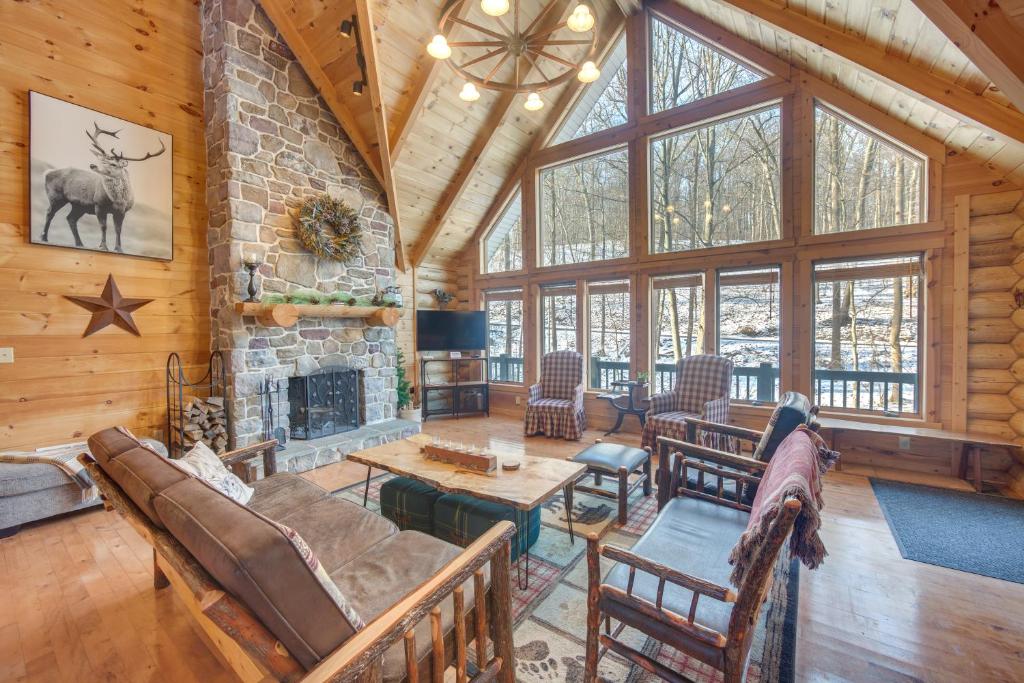 a living room with a fireplace in a log cabin at Grand 4,000 Sq Ft House - 11 Miles to Lancaster! in New Providence