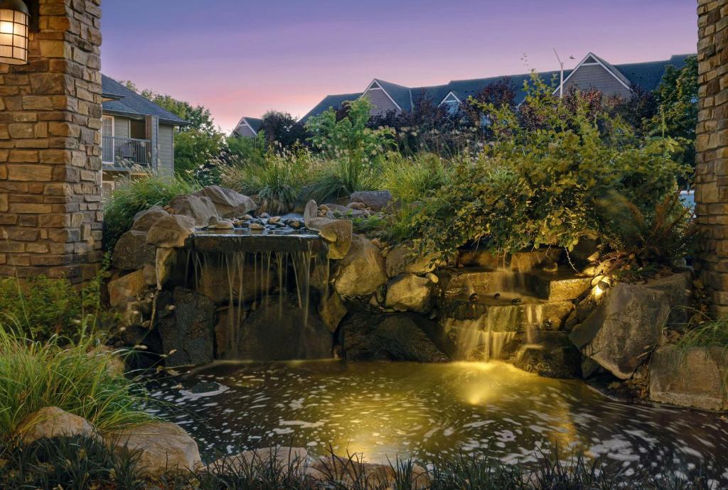 a pond in a yard with a waterfall at Homewood Suites by Hilton Vancouver / Portland in Vancouver