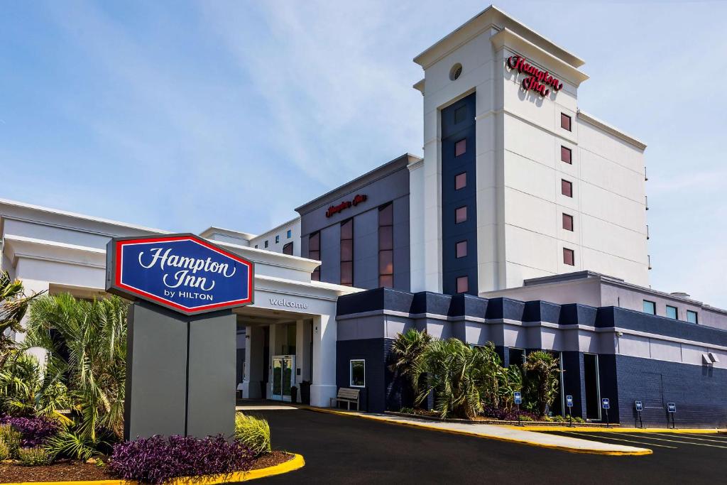 a hotel with a sign in front of a building at Hampton Inn Virginia Beach Oceanfront North in Virginia Beach