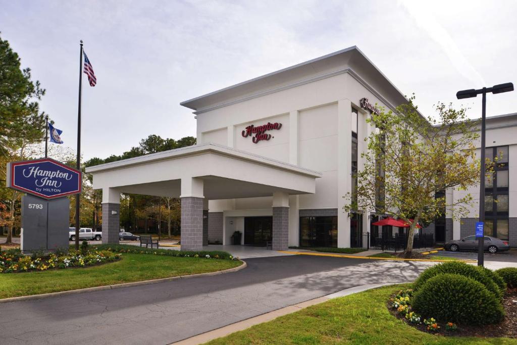 a white building with a sign in front of it at Hampton Inn Norfolk/Virginia Beach in Virginia Beach