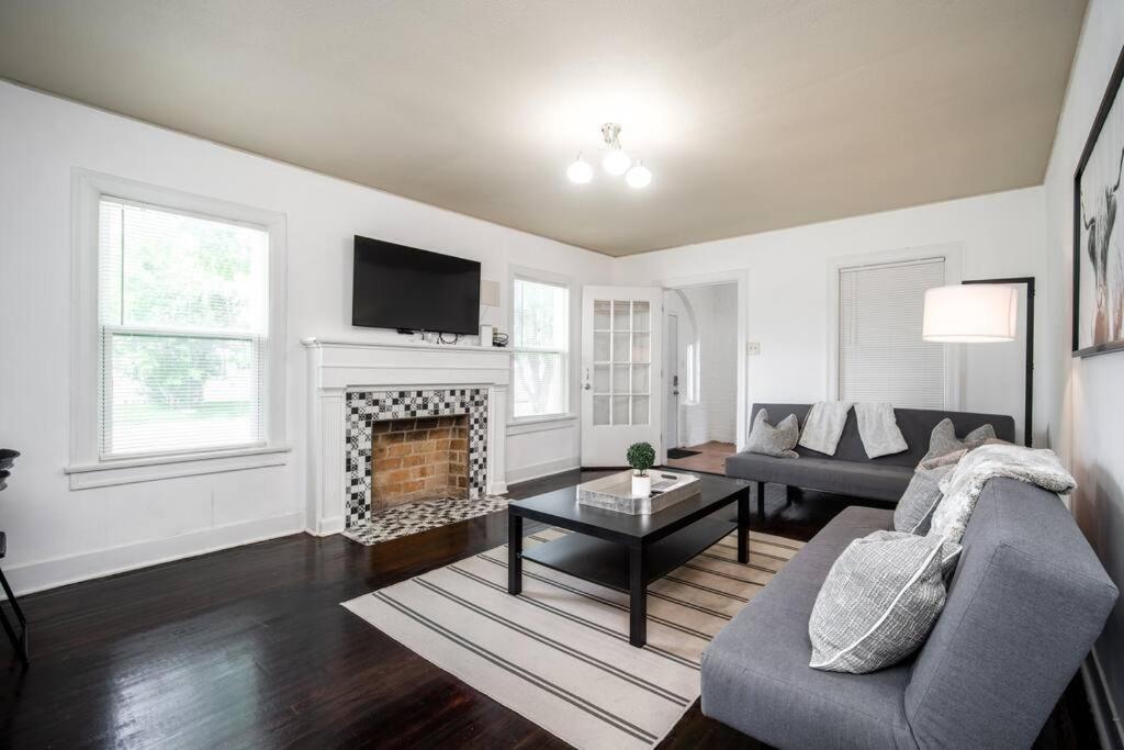 a living room with a couch and a fireplace at Trendy Apartment in Downtown - Near Montrose in Houston