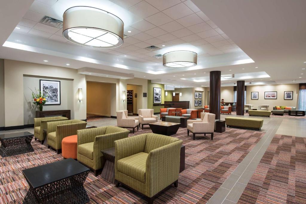 a lobby with a waiting room with couches and chairs at DoubleTree by Hilton Hotel Grand Rapids Airport in Grand Rapids