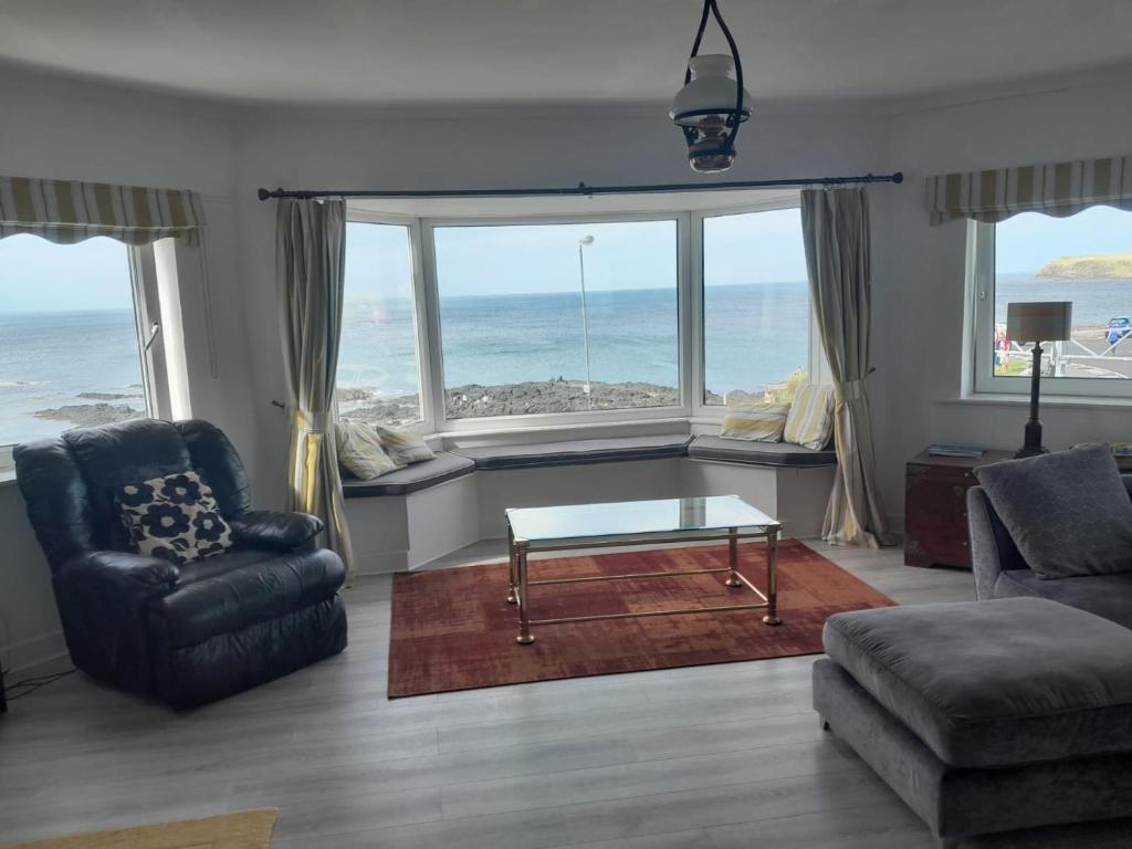 a living room with a view of the ocean at Beach lodge Stunning Sea Views in Portballintrae