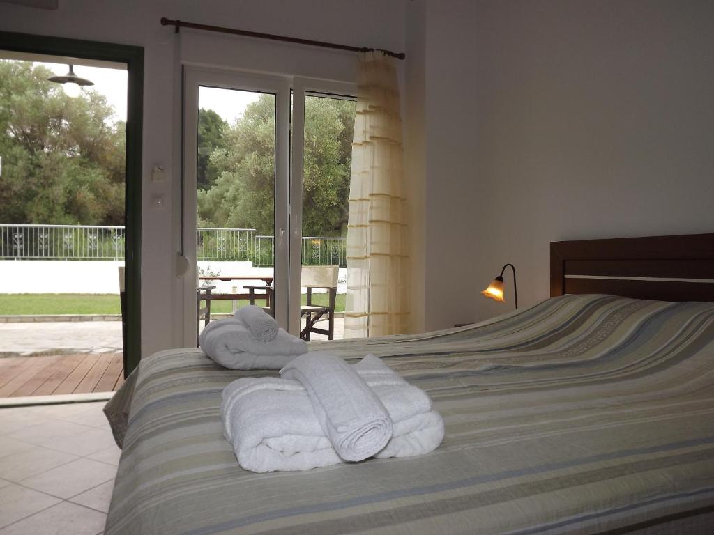 a bedroom with a bed with towels on it at Istira in Possidi