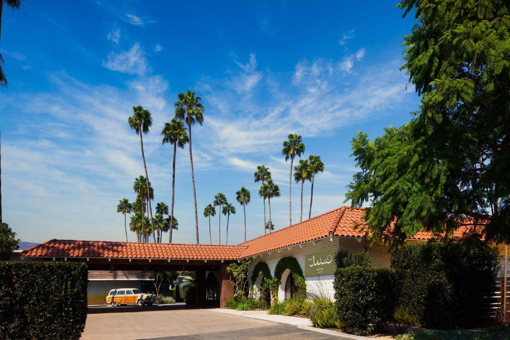 a building with palm trees in the background at The Leta Santa Barbara Goleta, Tapestry Collection by Hilton in Santa Barbara