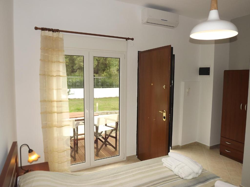 a bedroom with a sliding glass door to a balcony at Istira in Possidi
