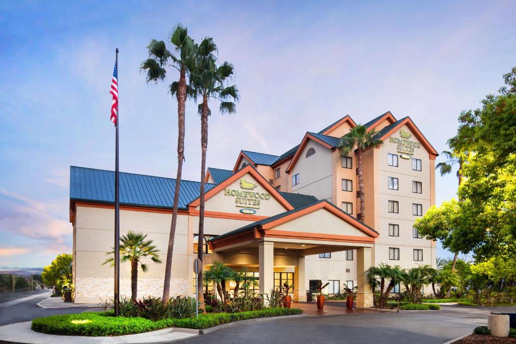 a hotel with an american flag in front of it at Homewood Suites by Hilton-Anaheim in Anaheim