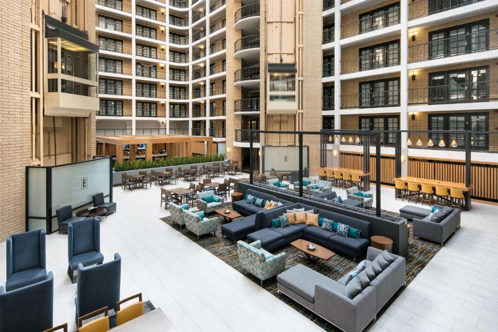 un patio all'ultimo piano con divani e tavoli di Embassy Suites by Hilton Austin Central ad Austin