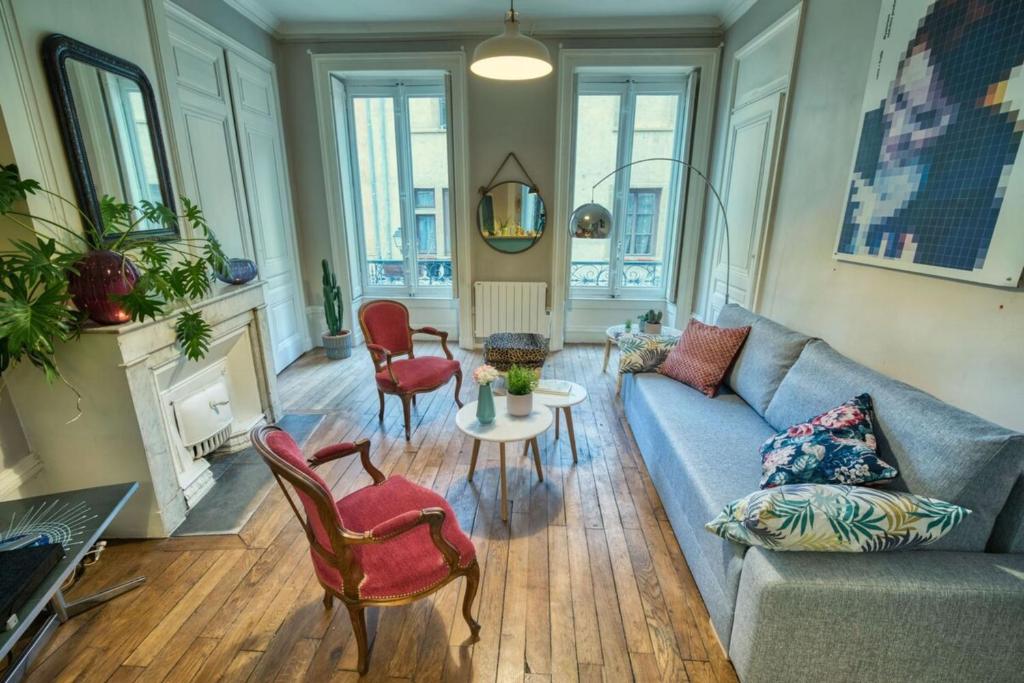 a living room with a couch and chairs and a table at Le Boudoir Vieux Lyon-Fourviere 4 pers in Lyon