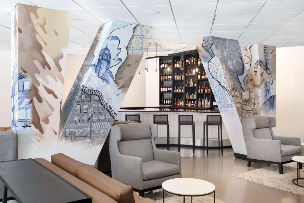 a room with chairs and a wall with a mural at Onyx Boston Downtown in Boston