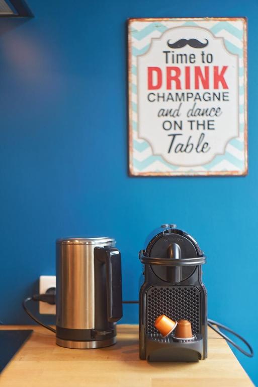 a coffee maker and a toaster on a table at Charmant cocon lyonnais Sathonay-Terreaux in Lyon