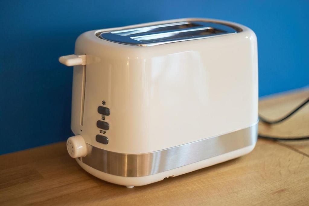 a toaster sitting on top of a wooden table at Charmant cocon lyonnais Sathonay-Terreaux in Lyon