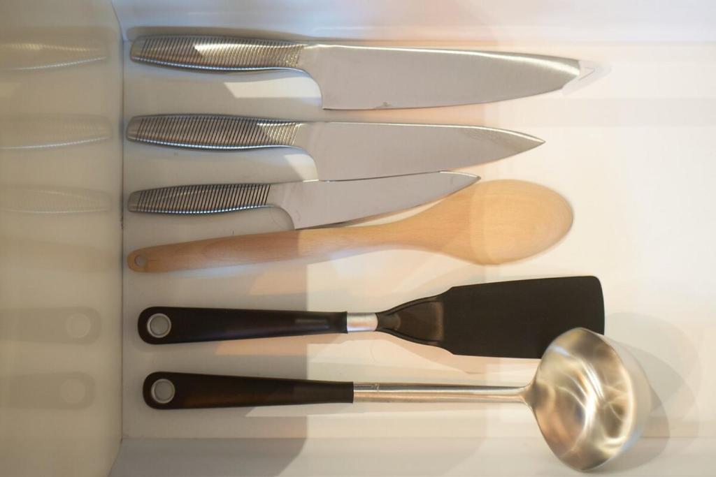 a group of kitchen utensils in a drawer at Charmant cocon lyonnais Sathonay-Terreaux in Lyon