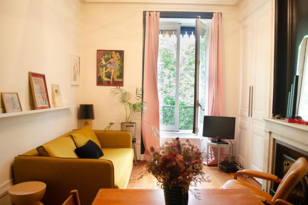 a living room with a couch and a window at Chez Julie -métro Garibaldi- Université in Lyon